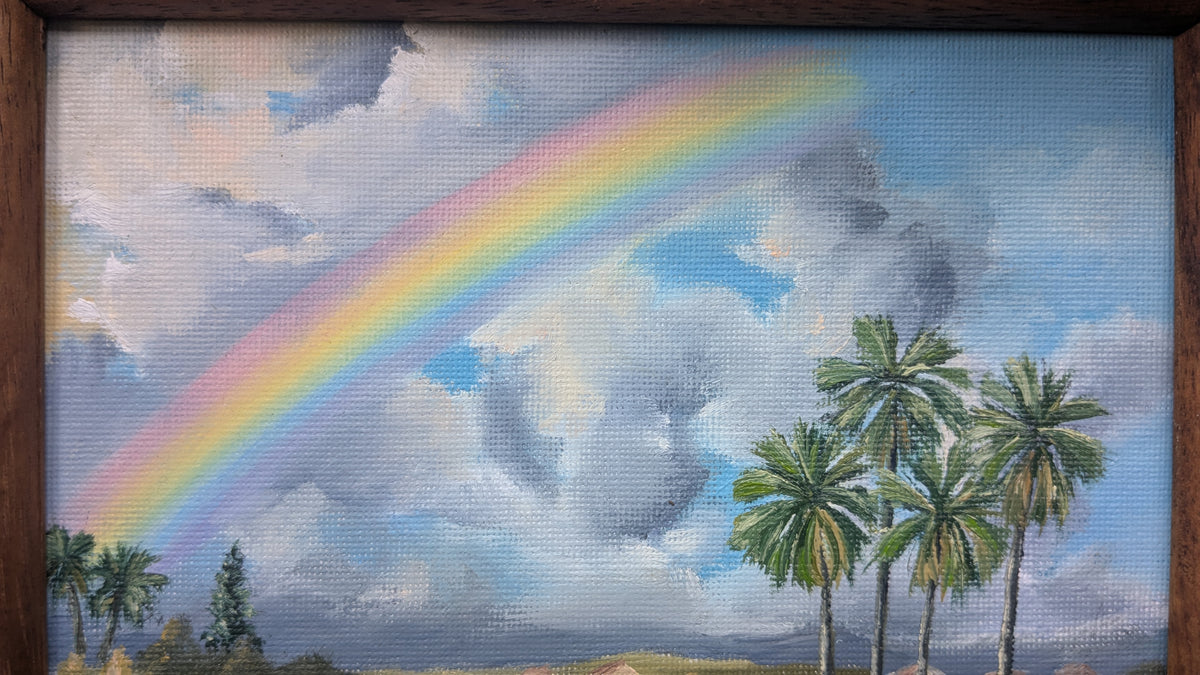 Painting of a rainbow and palm trees in a blue sky with clouds