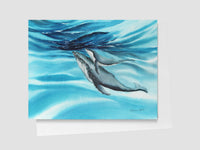 Artistic depiction of humpback whales swimming underwater with blue water and light effects.