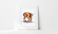 Matted artwork of a deer and fawn on a white wall