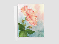 Greeting card of a floral painting of a pink hibiscus flower with green leaves on a watercolor background